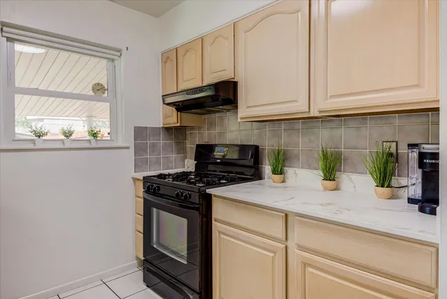 a kitchen with white cabinets and appliances