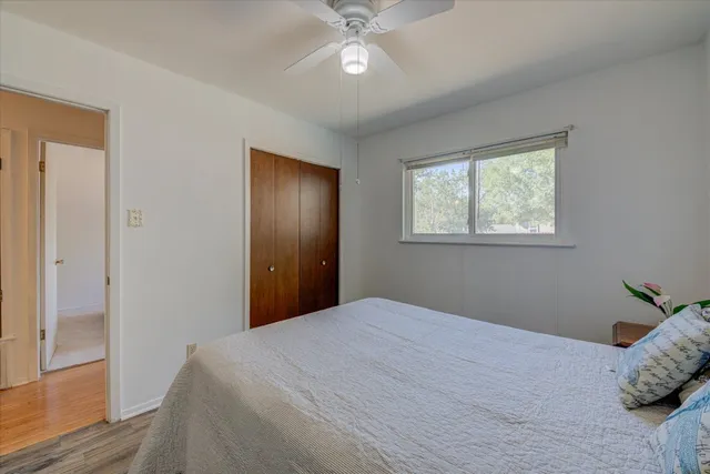 a bedroom with a large bed and a chandelier