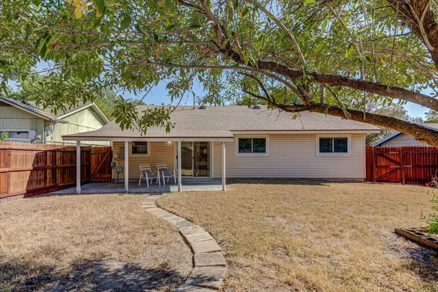 a house view with a sitting space and garden