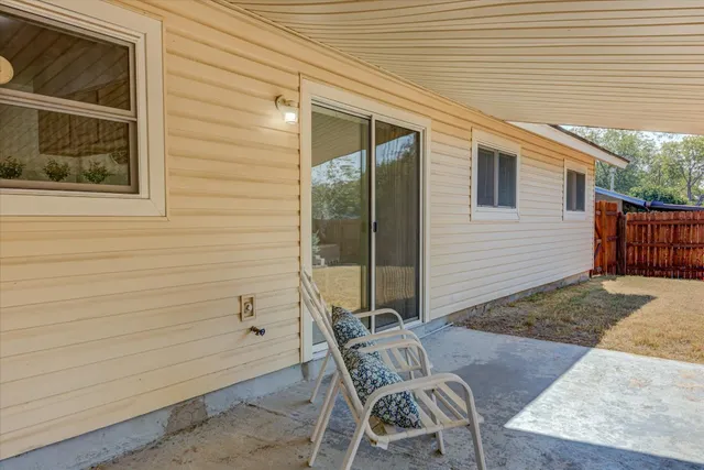a view of backyard with a chair and table
