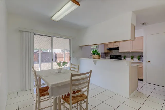 a kitchen with appliances cabinets and a table chair