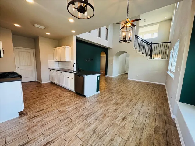 a view of kitchen and living room with wooden floor