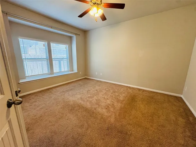 a view of a kitchen with kitchen island a sink wooden floor and a large window