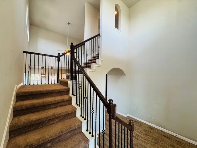 a view of a hallway view with wooden floor and staircase