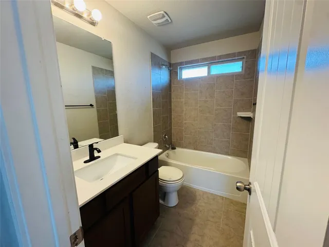 an empty room with closet and a chandelier fan