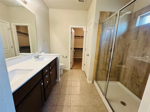 a bathroom with a sink a mirror a bathtub and shower