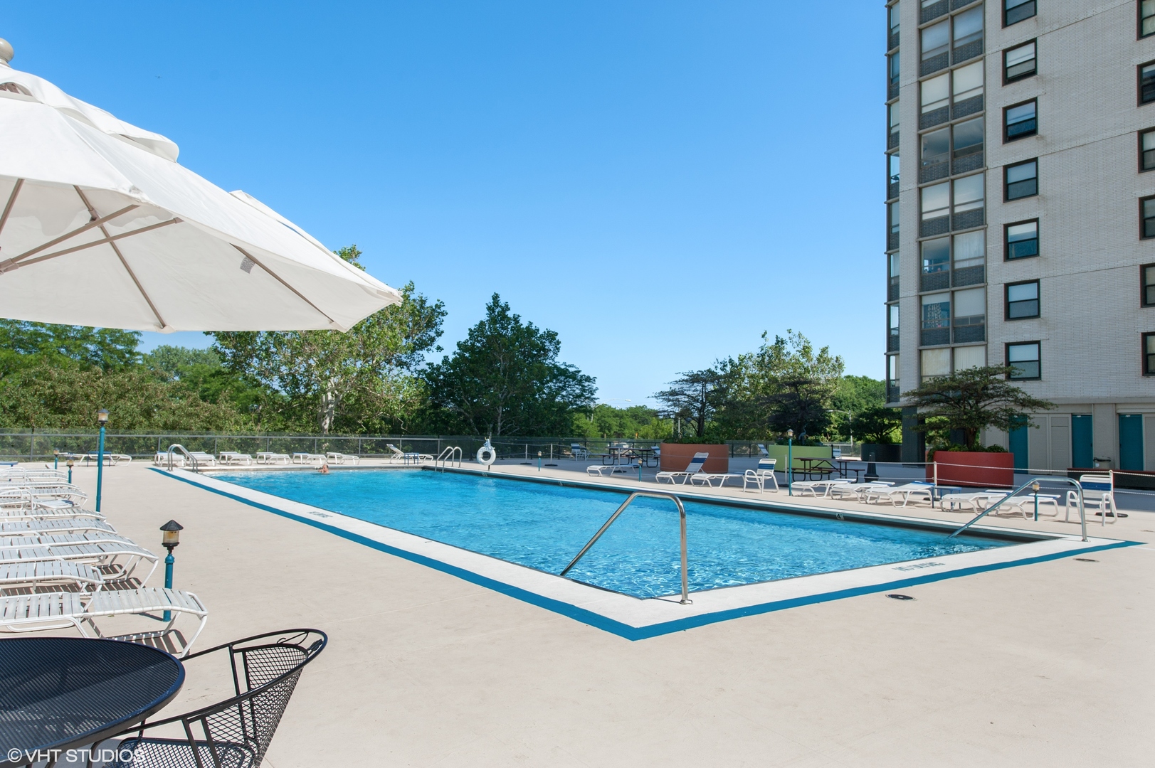 5701 North Sheridan Road, Unit 27M Chicago, IL 60660 - Photo 14 of 20 a view of a swimming pool with a lounge chair