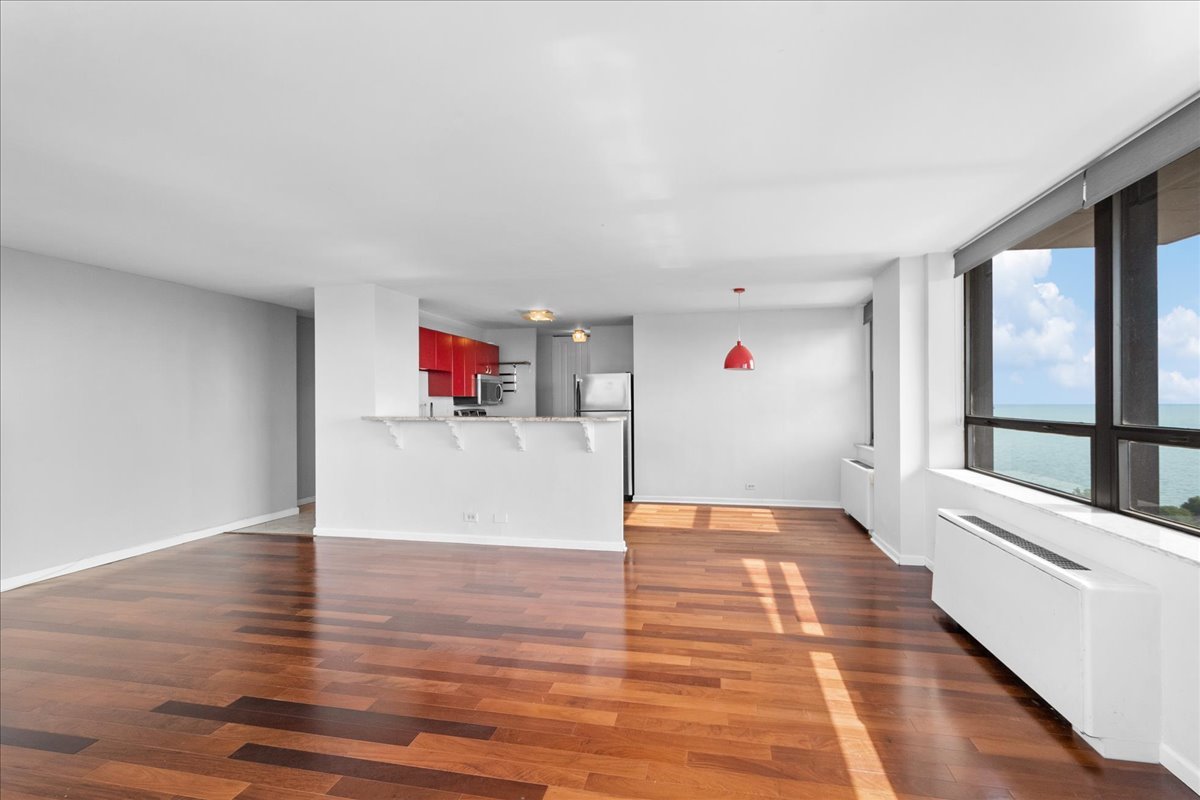 5701 North Sheridan Road, Unit 27M Chicago, IL 60660 - Photo 4 of 20 a view of a room with wooden floor and windows