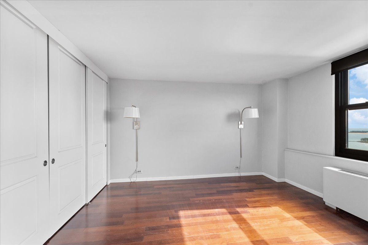 5701 North Sheridan Road, Unit 27M Chicago, IL 60660 - Photo 10 of 20 a view of a room with wooden floor and window