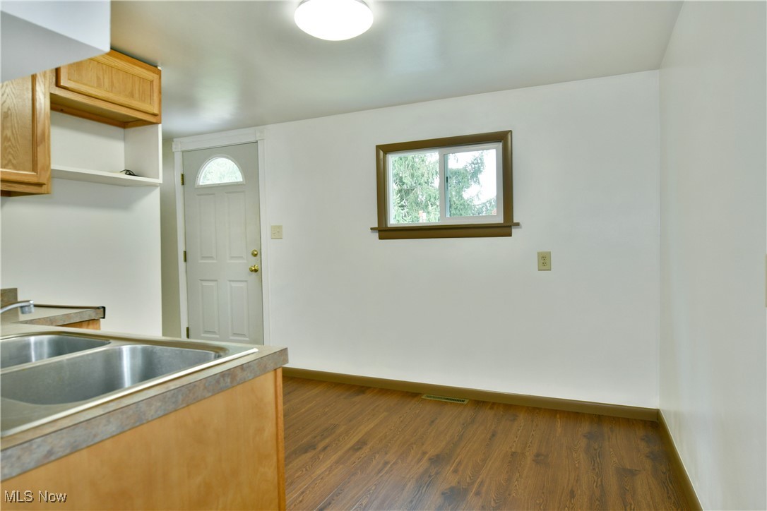 5150 Phillips Rice Road Cortland, OH 44410 - Photo 32 of 50 Kitchen with healthy amount of natural light, dark wood-style flooring, open shelves, and light countertops