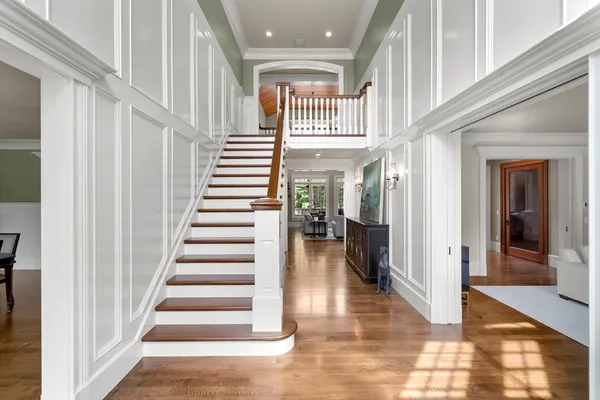 a view of entryway and hall with wooden floor