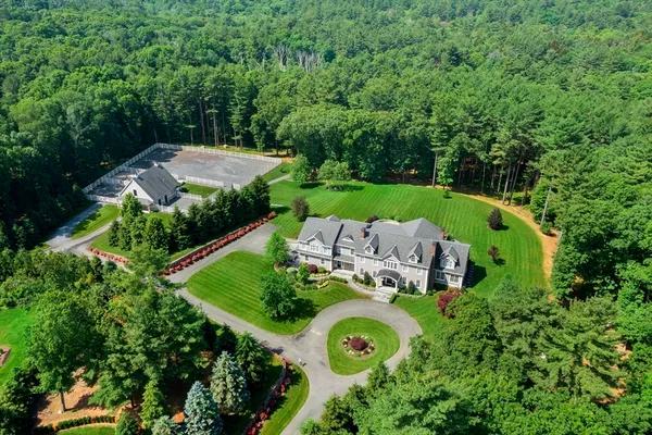 an aerial view of a house with garden space and street view