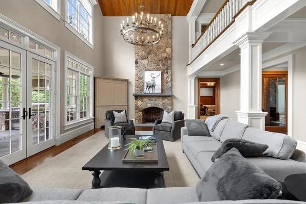 a living room with furniture fireplace and a large window