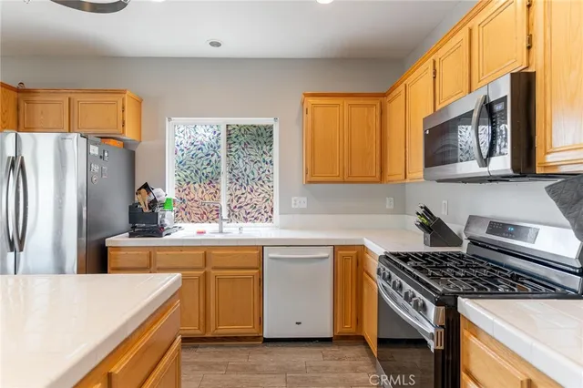 a kitchen with a stove a sink and a refrigerator