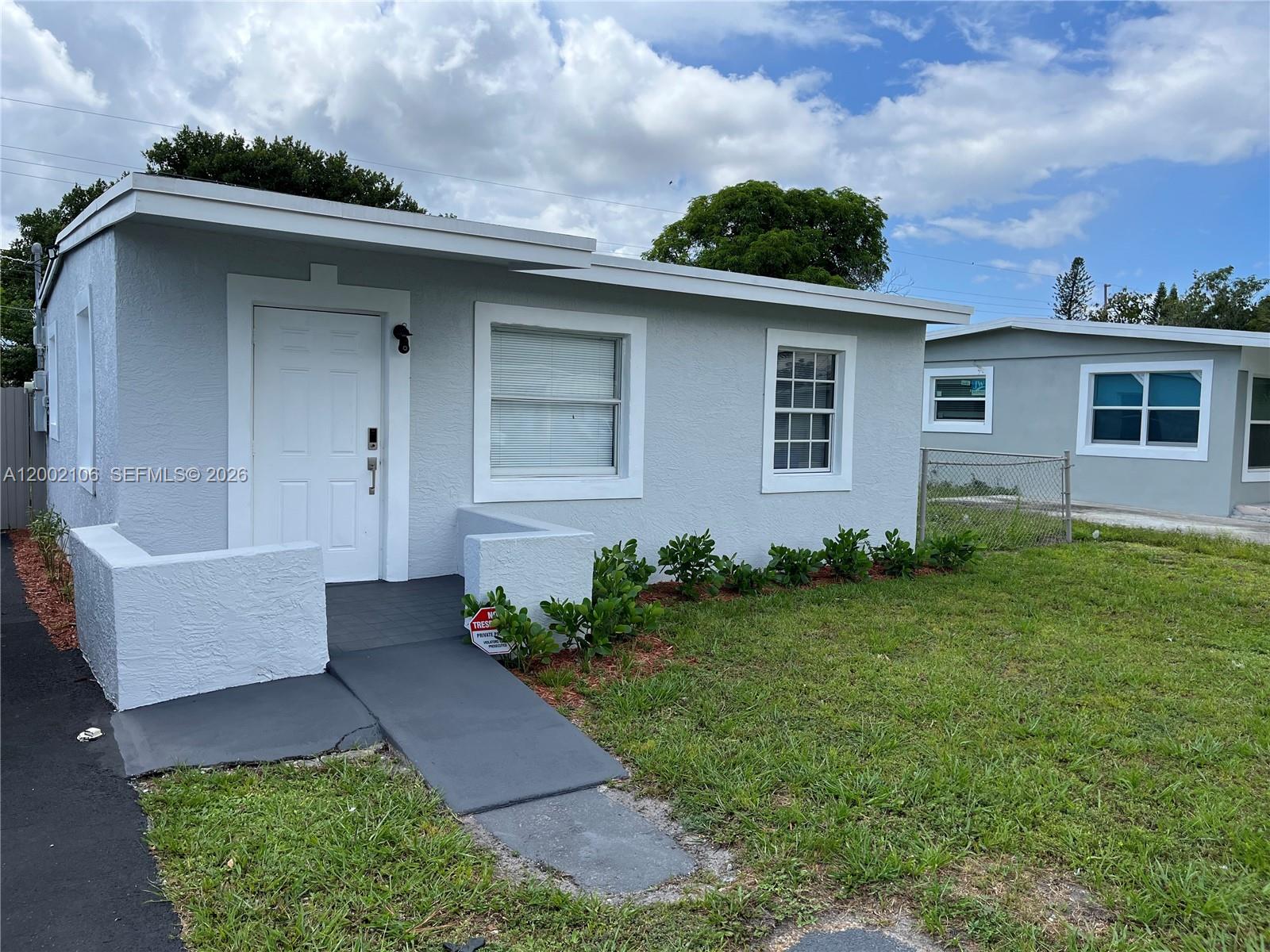 2726 Northwest 4th Court Pompano Beach, FL 33069 - Photo 1 of 11 a front view of a house with garden