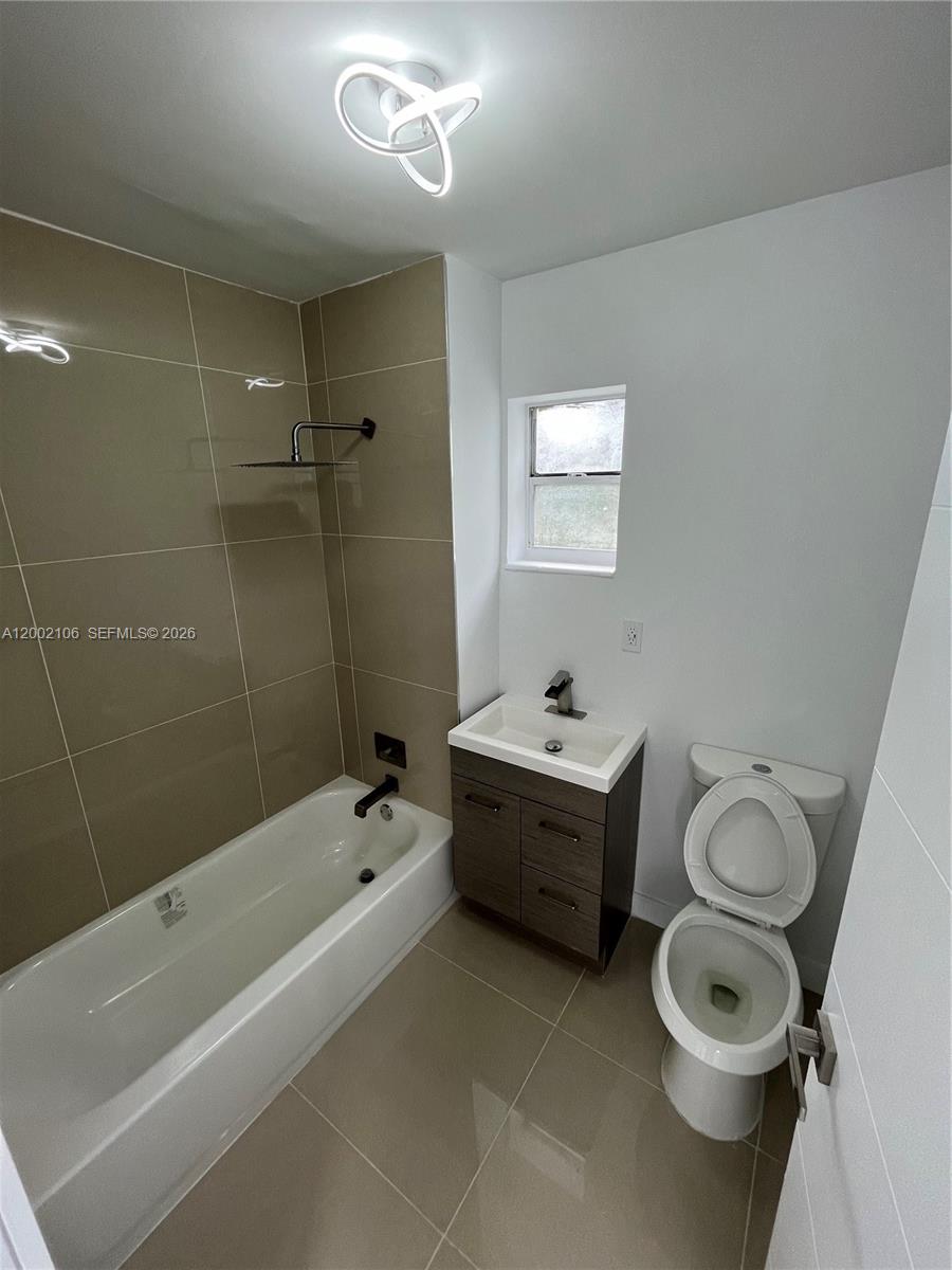 2726 Northwest 4th Court Pompano Beach, FL 33069 - Photo 11 of 11 a bathroom with a sink a toilet and shower