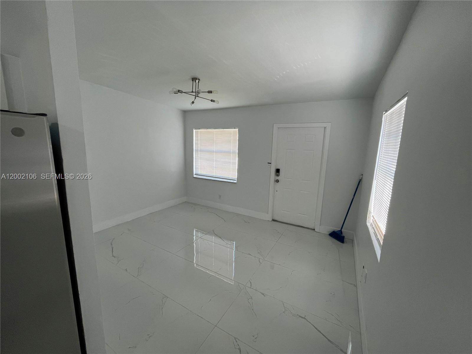 2726 Northwest 4th Court Pompano Beach, FL 33069 - Photo 4 of 11 a view of an empty room with a window
