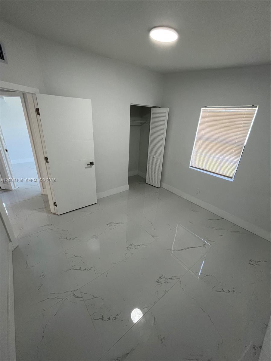 2726 Northwest 4th Court Pompano Beach, FL 33069 - Photo 6 of 11 an empty room with a window
