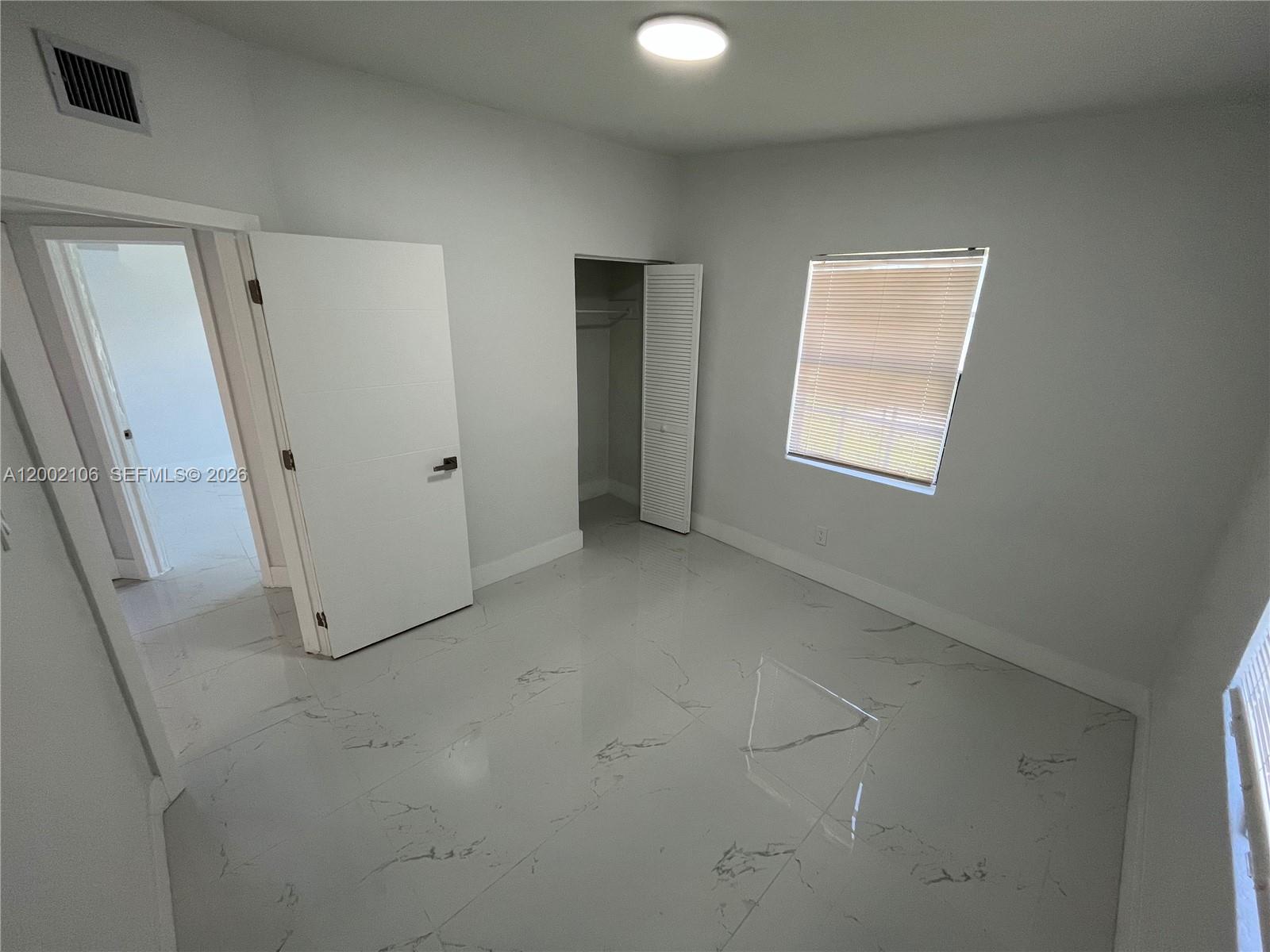 2726 Northwest 4th Court Pompano Beach, FL 33069 - Photo 7 of 11 a view of a livingroom with an empty space