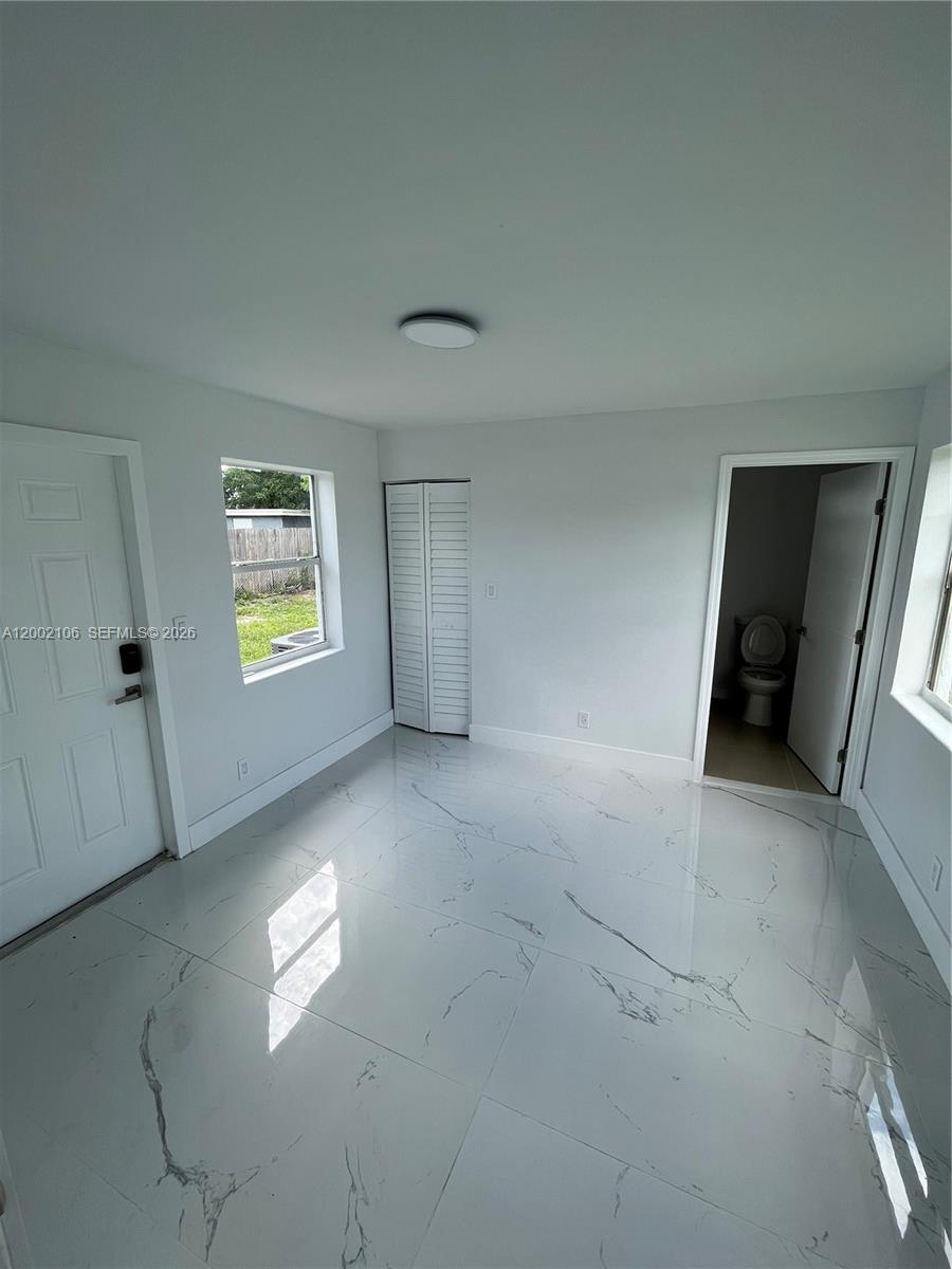 2726 Northwest 4th Court Pompano Beach, FL 33069 - Photo 10 of 11 a view of an empty room with a window