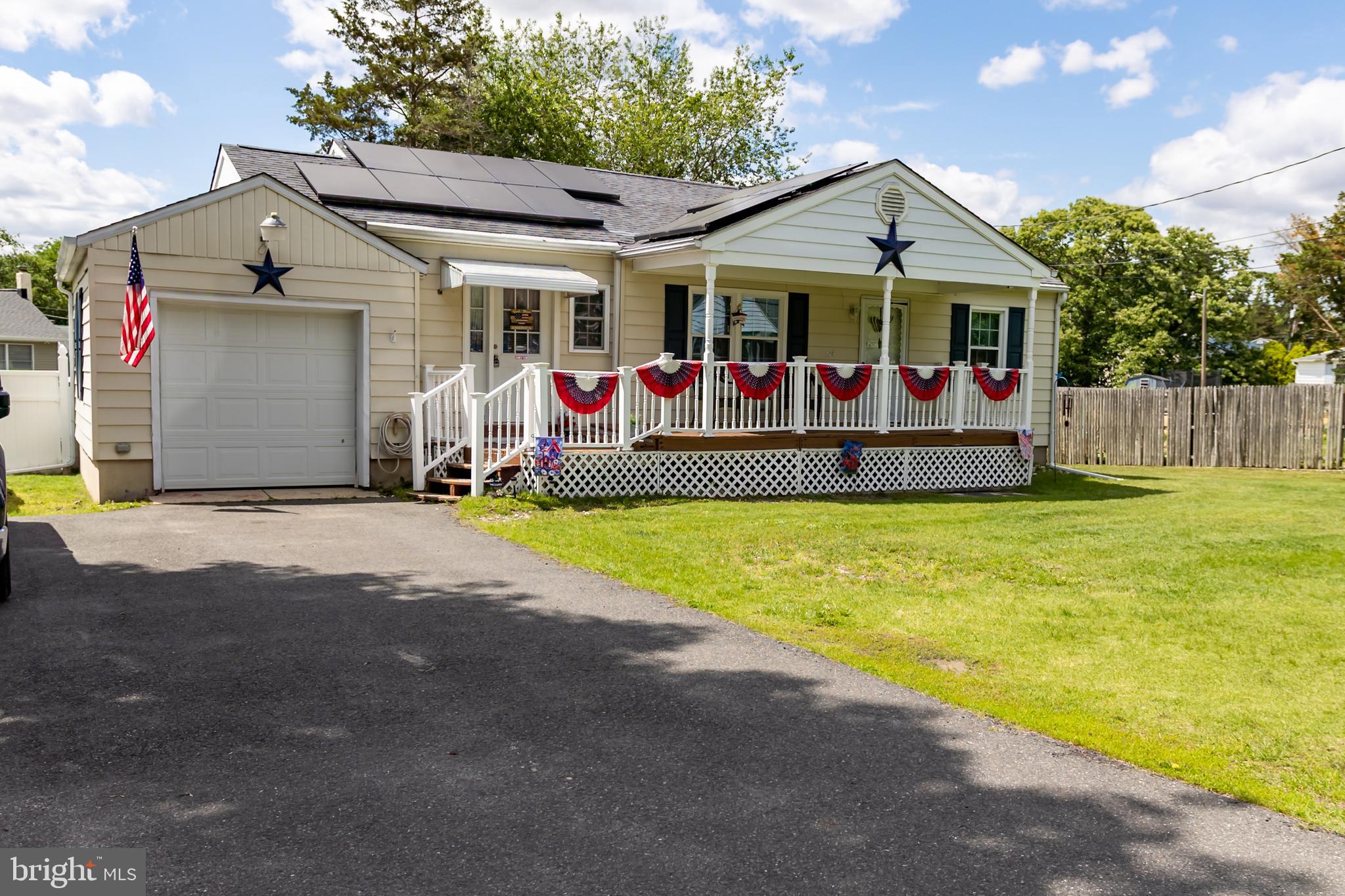 a view of a house with wooden fence