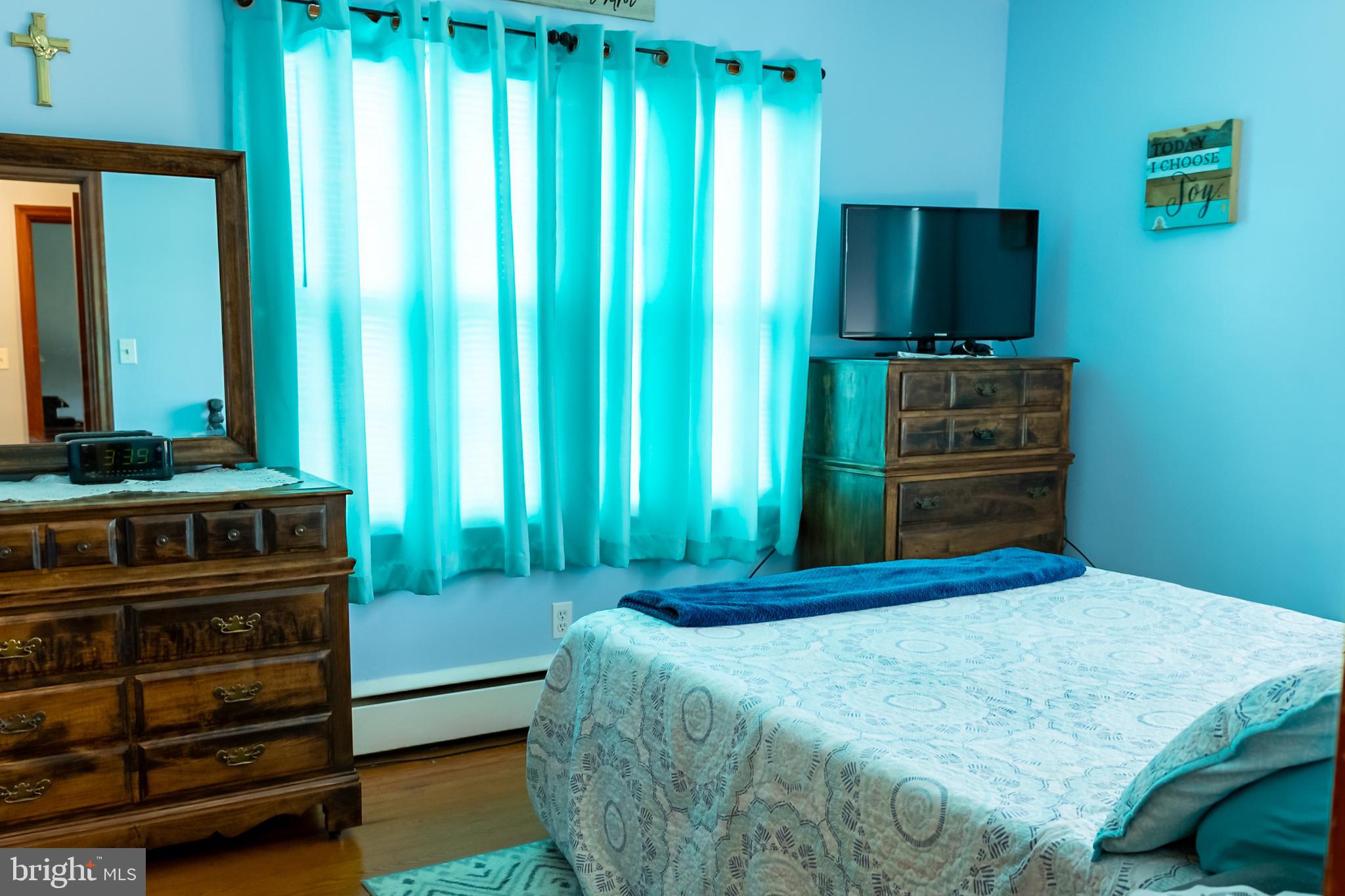 106 Centerton Road Bridgeton, NJ 08302 - Photo 15 of 31 a bedroom with a bed and a flat tv screen