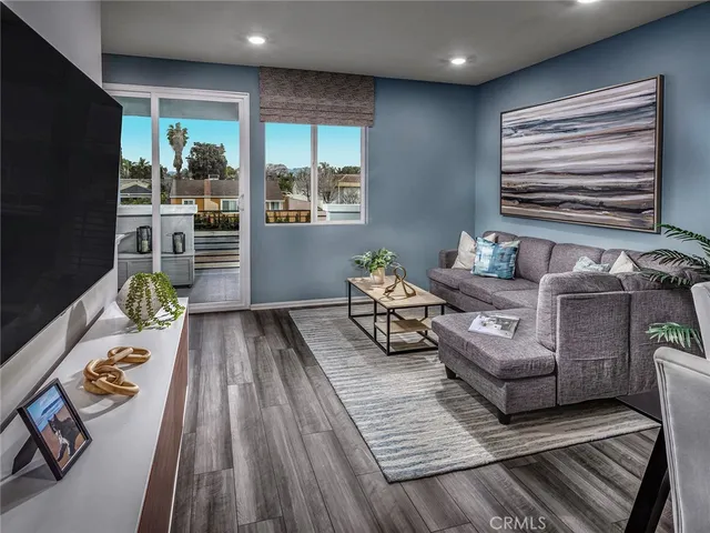 a living room with furniture and a potted plant