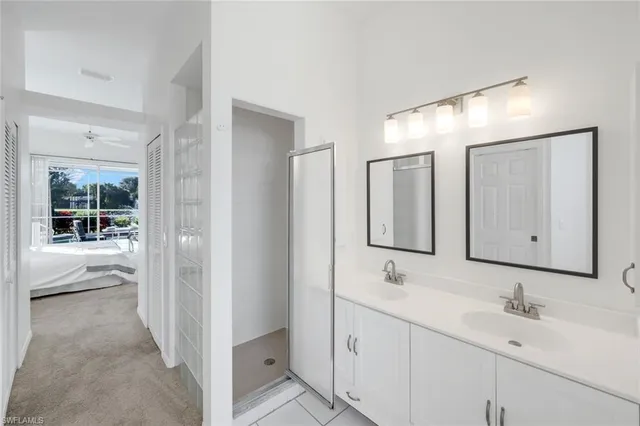 a bathroom with 2 sink and a mirror