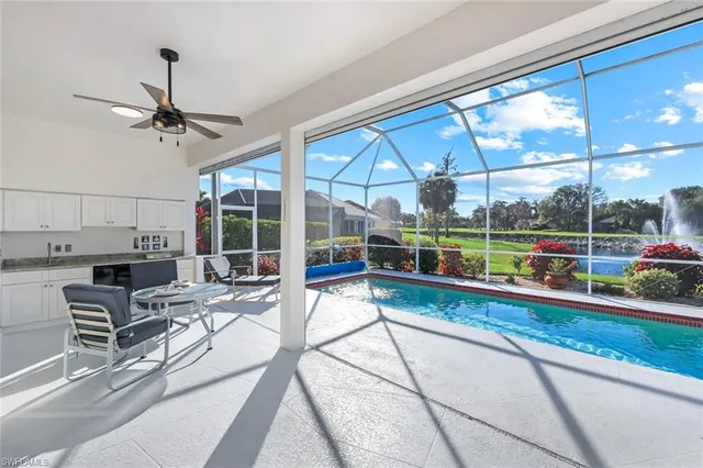 a view of a living room and kitchen with a floor to ceiling window