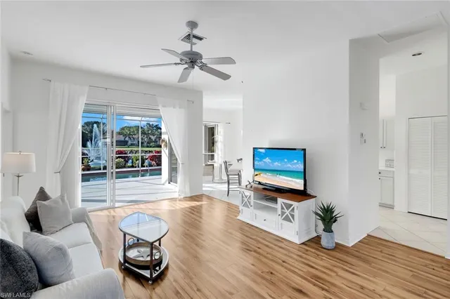 a living room with furniture wooden floor and a flat screen tv