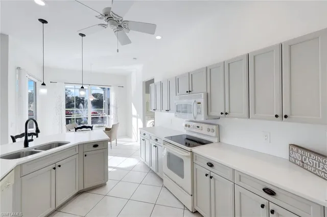 a kitchen with cabinets appliances and a sink