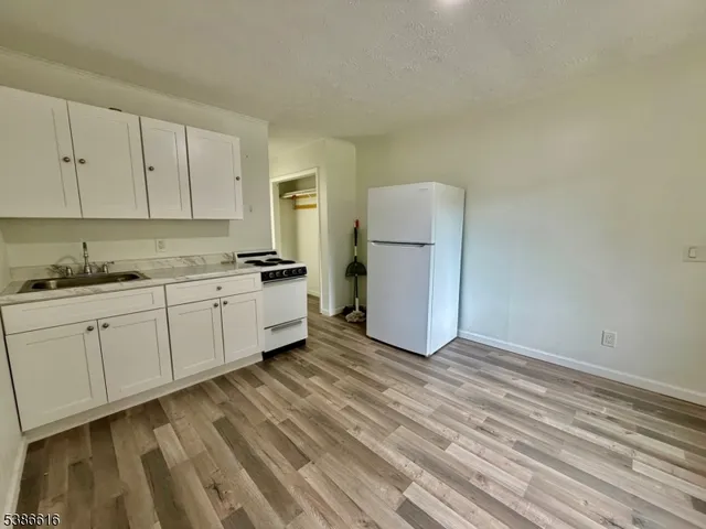 a kitchen with sink cabinets and white appliances