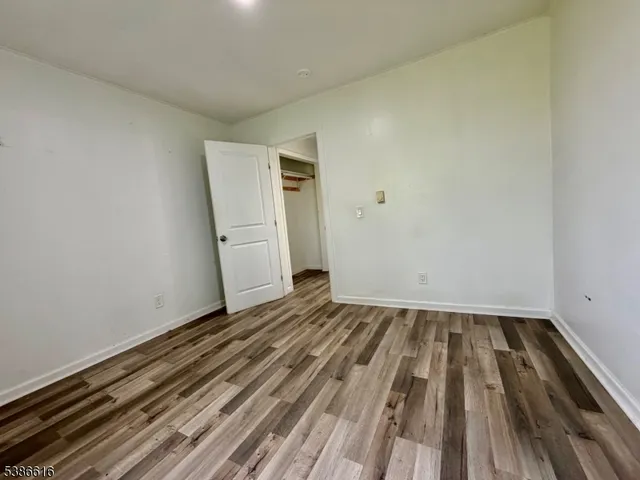 a view of room with wooden floor