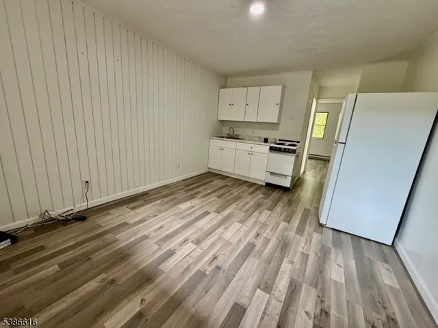 a room with a wooden floor and a sink