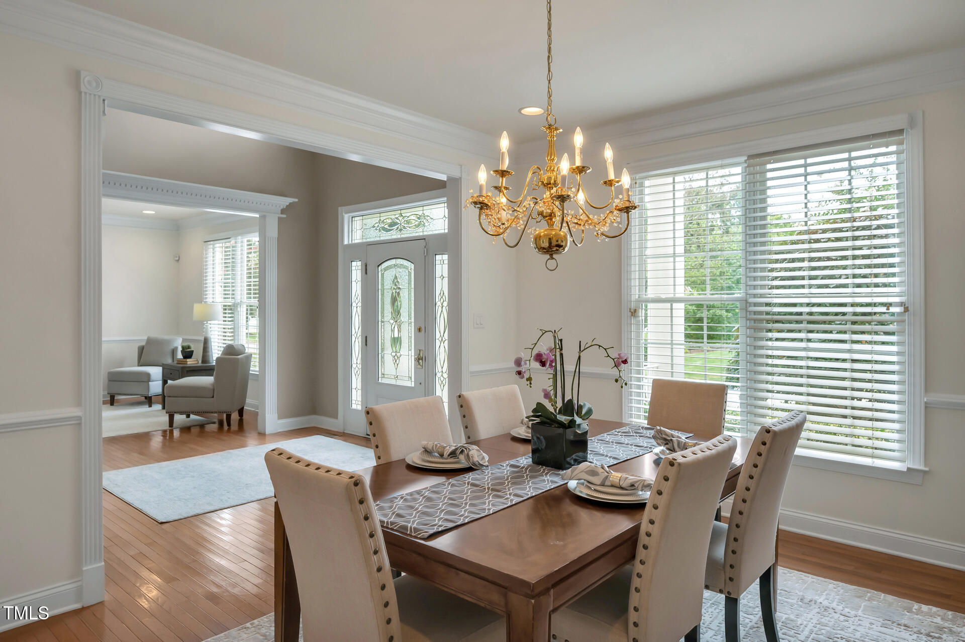 9628 Club Valley Way Raleigh, NC 27617 - Photo 11 of 68 a view of a dining room with furniture a chandelier and wooden floor