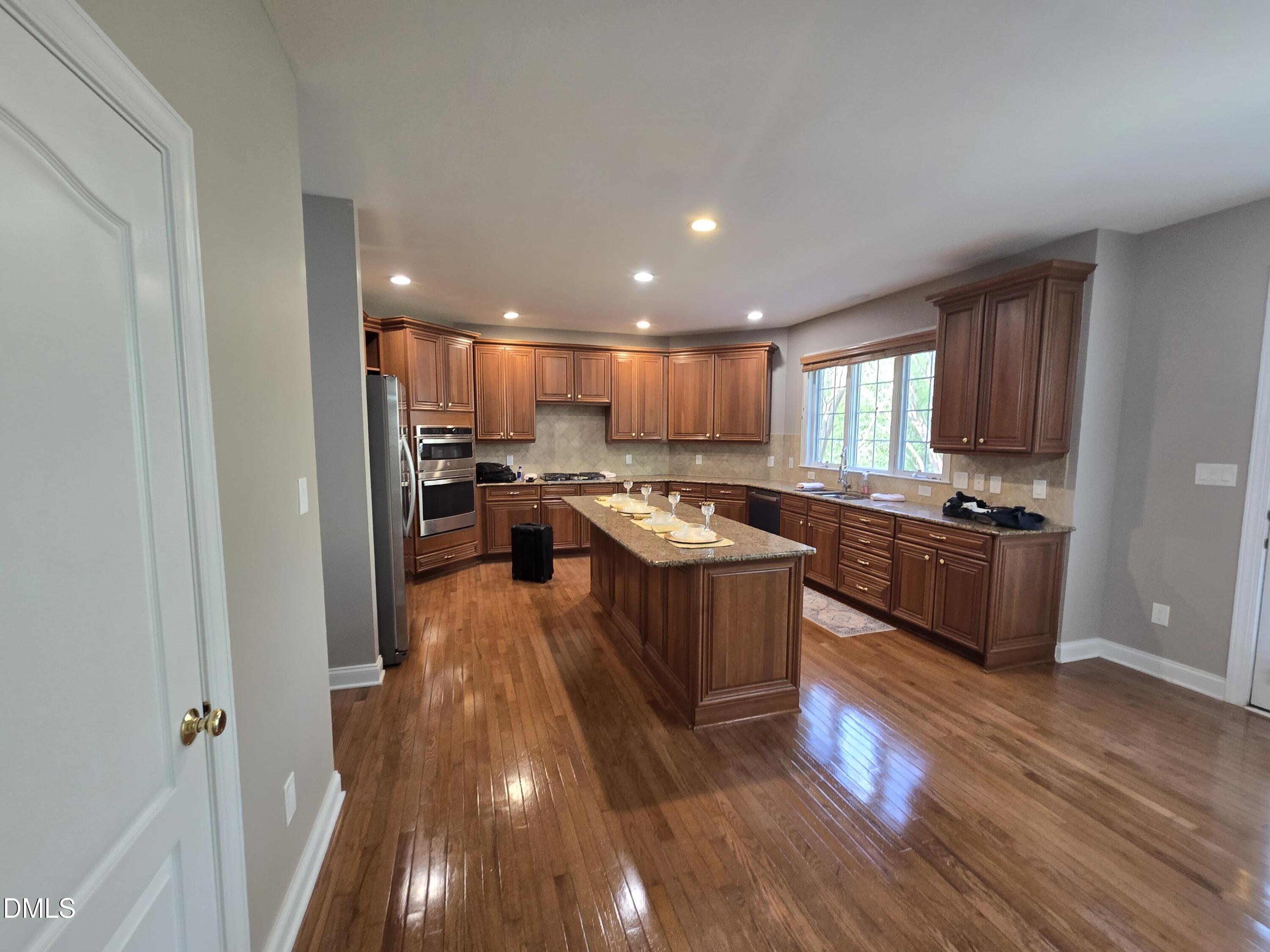 9628 Club Valley Way Raleigh, NC 27617 - Photo 17 of 68 a kitchen with a sink and a stove top oven