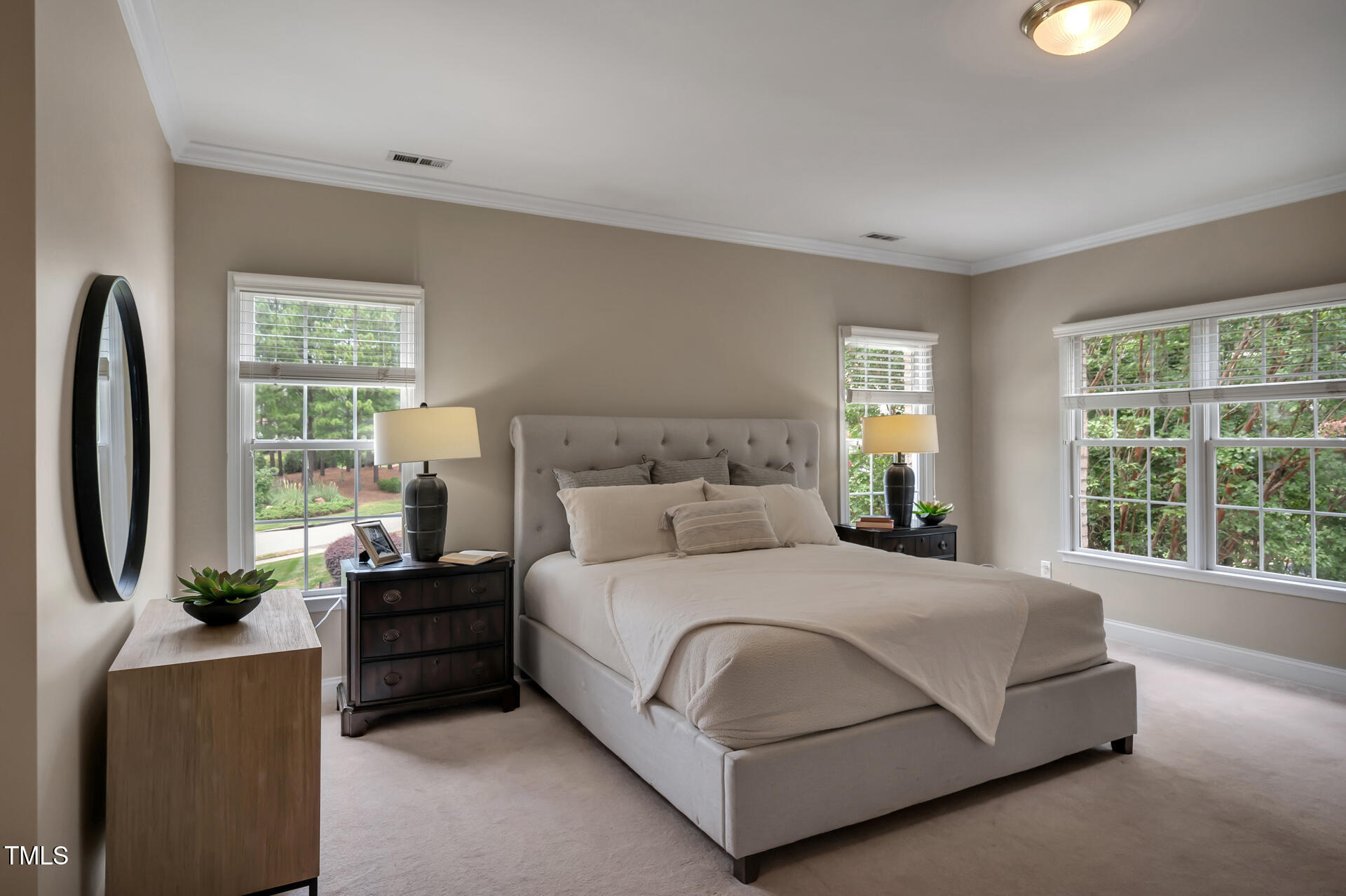 9628 Club Valley Way Raleigh, NC 27617 - Photo 31 of 68 a bedroom with a large bed and a flat tv screen on dresser