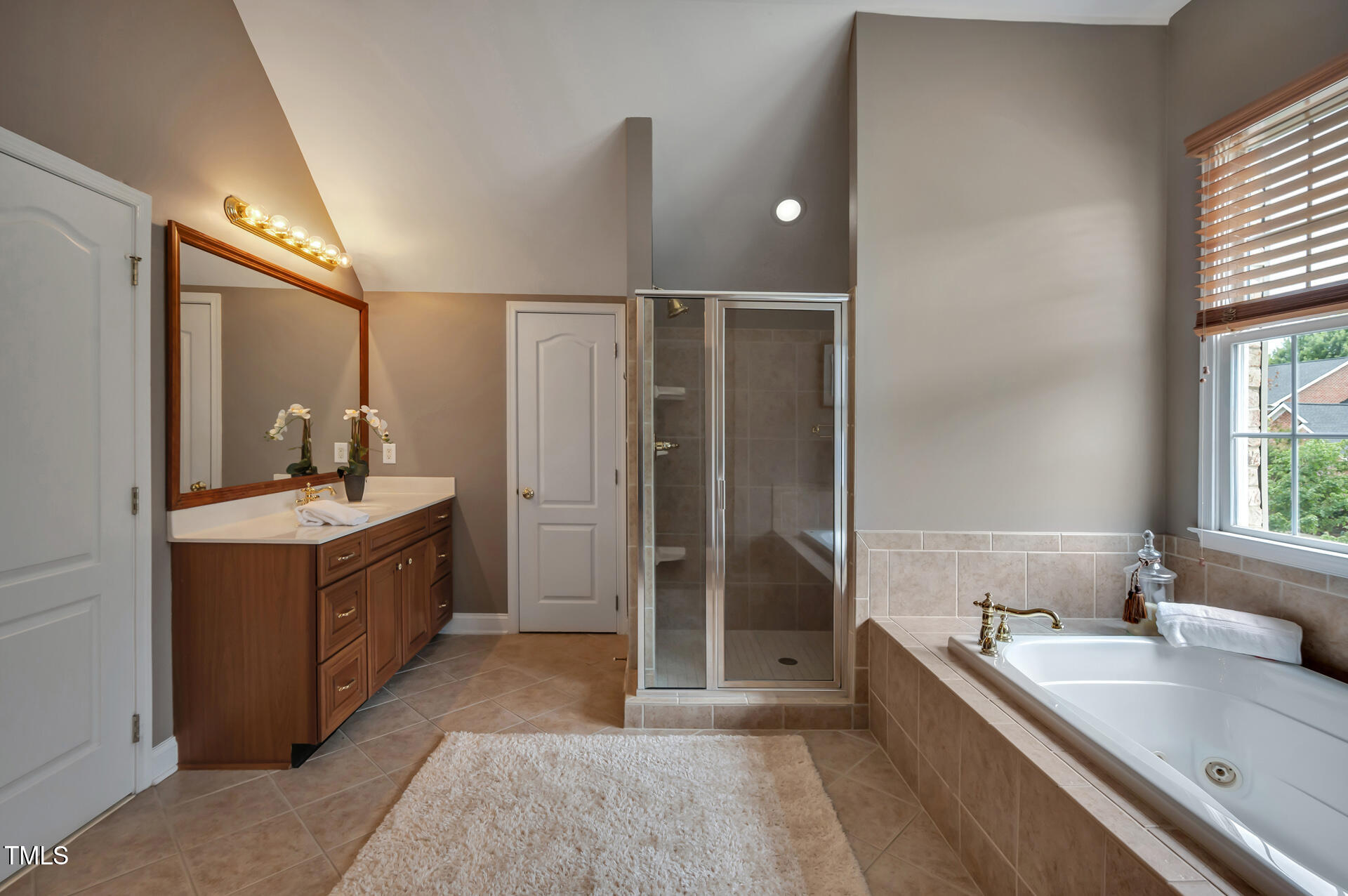9628 Club Valley Way Raleigh, NC 27617 - Photo 35 of 68 a bathroom with a tub sink shower and mirror