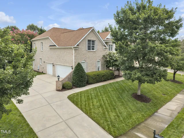 an aerial view of residential houses with outdoor space and street view