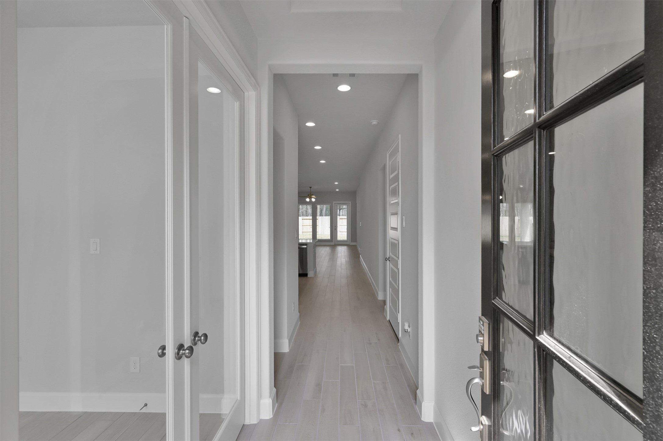 15715 Autumn Sun Conroe, TX 77302 - Photo 3 of 23 a view of a hallway with wooden floor
