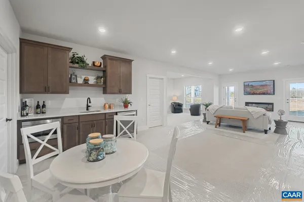 a living room with furniture and a sink