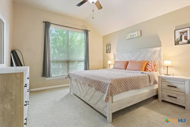 a bedroom with a bed and a night stand