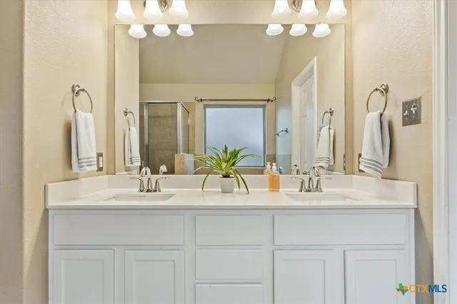 a bathroom with a bathtub sink and mirror
