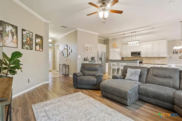 a kitchen with granite countertop white cabinets and stainless steel appliances