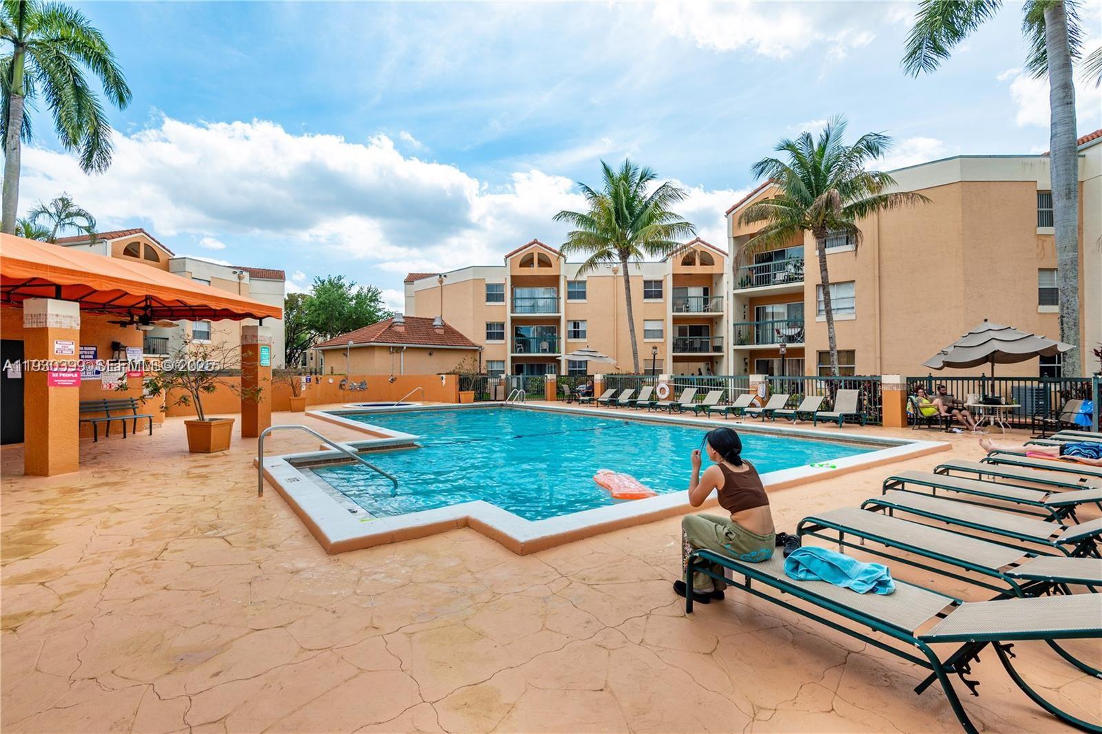 6292 Northwest 186th Street, Unit 214 Hialeah, FL 33015 - Photo 13 of 13 a swimming pool with outdoor seating and yard