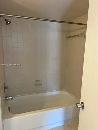 a bathroom with a shower and a bath tub