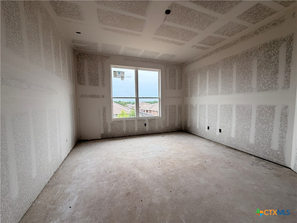 306 University Avenue Troy, TX 76579 - Photo 13 of 16 an empty room with a window and fireplace