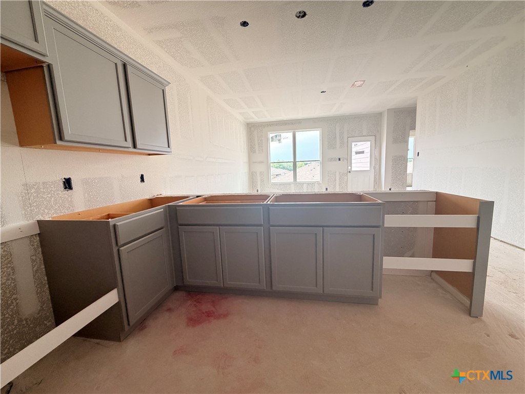 306 University Avenue Troy, TX 76579 - Photo 4 of 16 a kitchen with a sink cabinets and wooden floor