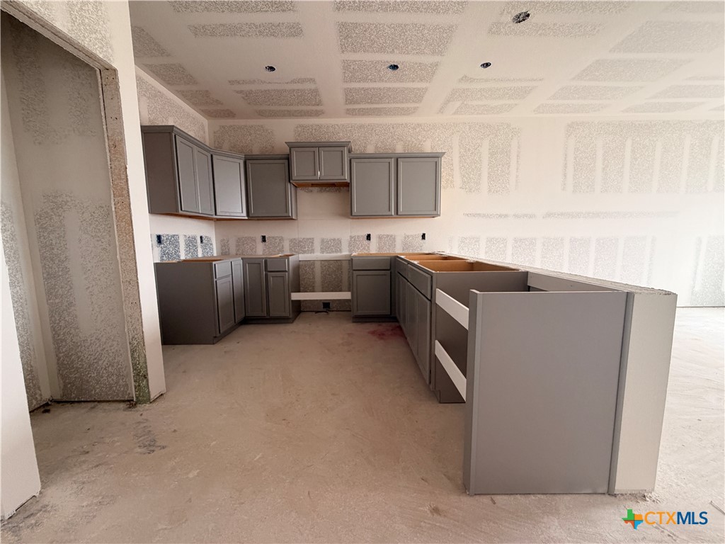 306 University Avenue Troy, TX 76579 - Photo 6 of 16 a kitchen with stainless steel appliances granite countertop a sink stove and refrigerator