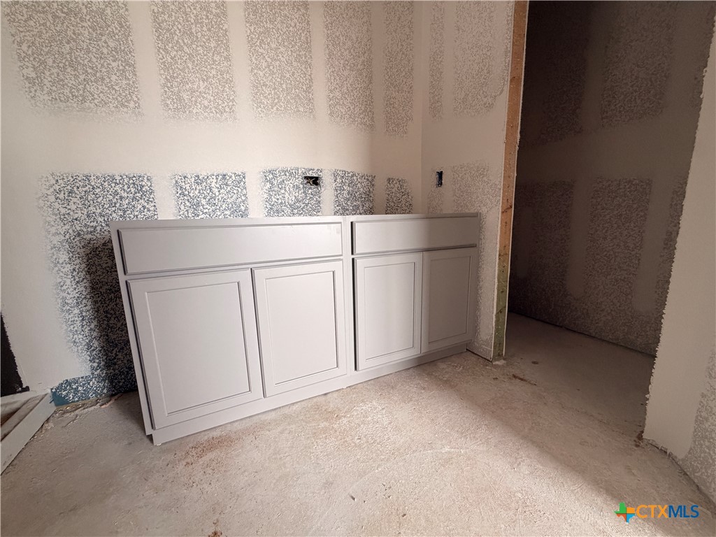 306 University Avenue Troy, TX 76579 - Photo 7 of 16 a view of cabinets and utility room with racks on the wall